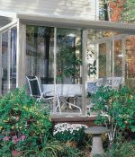 <p>Lots of glass for maximum sunlight! This studio style sunroom features sliding patio doors all around, and custom glass on the sides for added light and height.</p>

