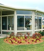 <p>Tom and Bonnie Carman visited home shows and looked at photos of sunrooms for years before choosing this custom designed four wall style. The angled glass windows let in plenty of sunshine and give a distinctive look to their home.</p>
