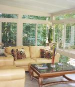 <p>Wouldn&rsquo;t you love to be relaxing here, looking at the trees and flowers through the expanse of glass in this glorious sunroom, beautifully appointed with leather couches and marble topped wood tables?</p>
